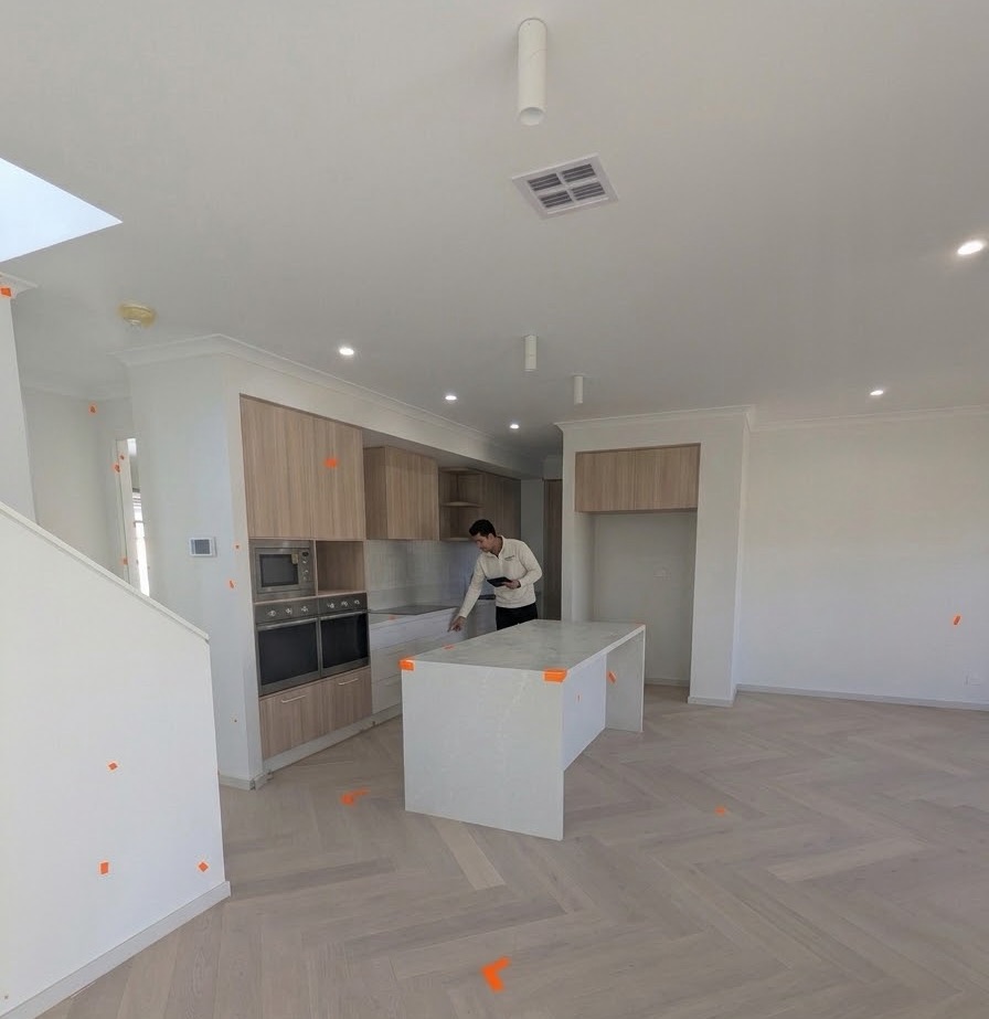 Nitpik inspector working through a new kitchen and living area with defect markers