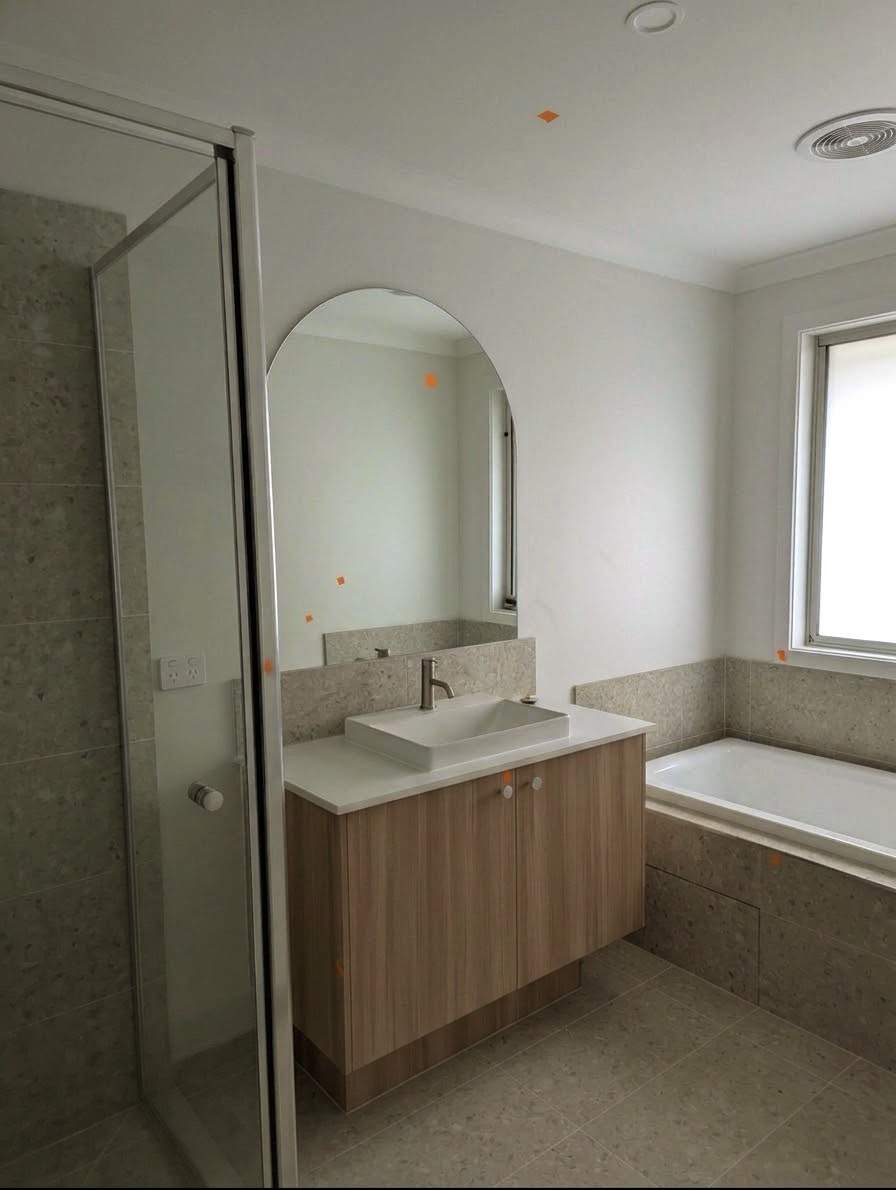 New bathroom inspected by Nitpik with defect markers on mirror and walls
