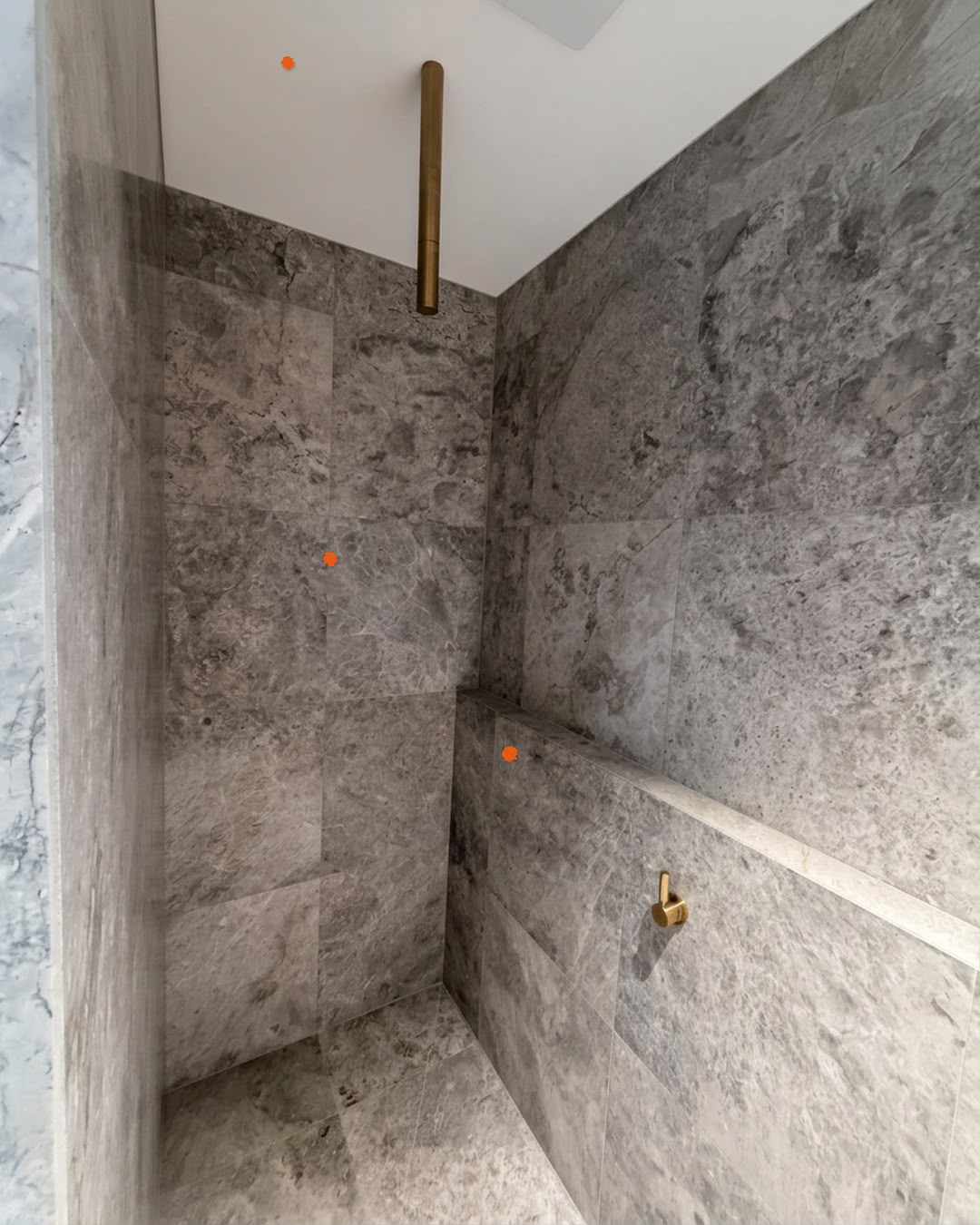 Stone shower with brass fittings marked with defect markers, Canterbury