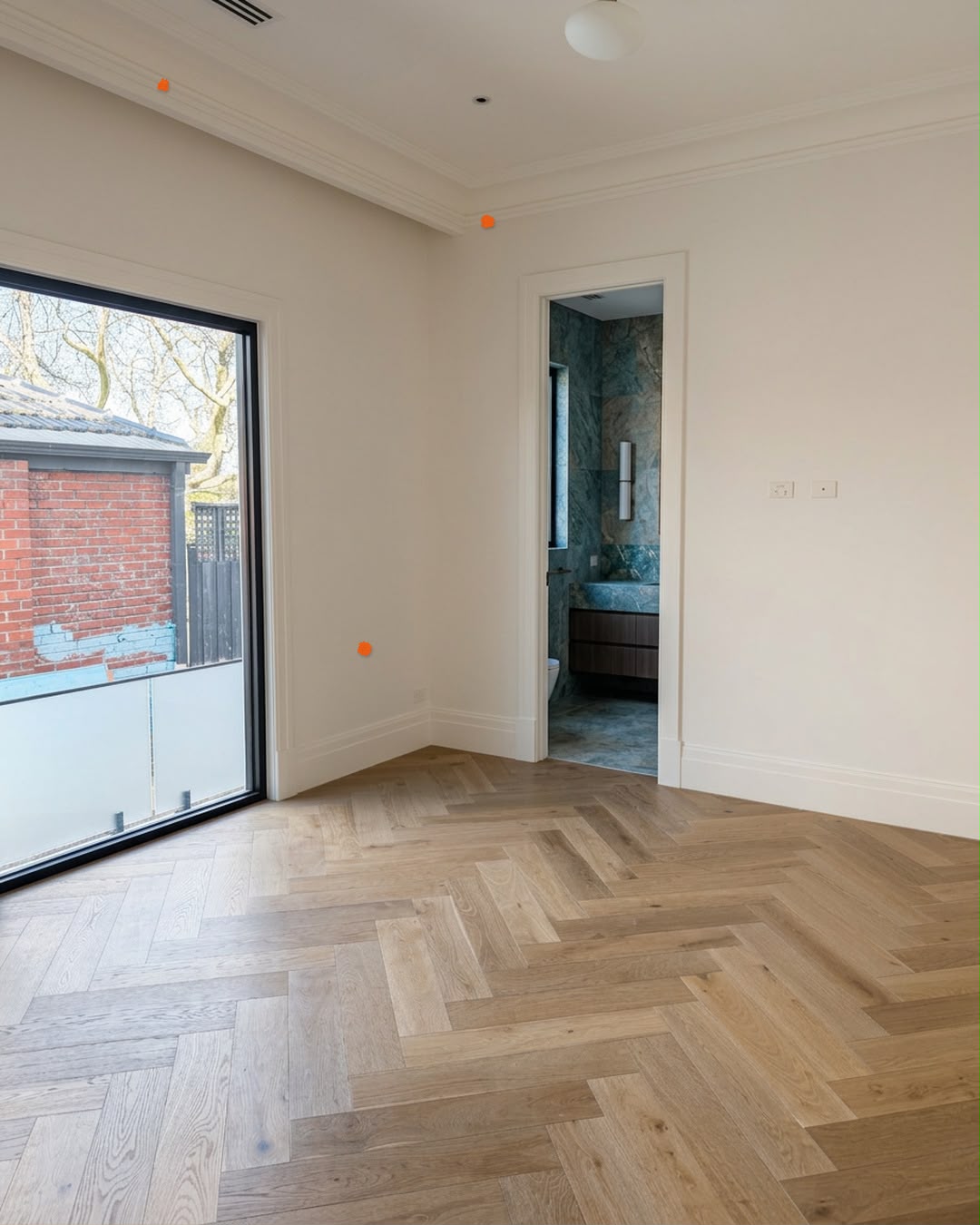 Bedroom with herringbone oak floor and ensuite doorway, marked with defect markers, Canterbury